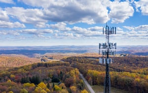 Remote radio frequency tower on a hilltop looking out across rolling hills